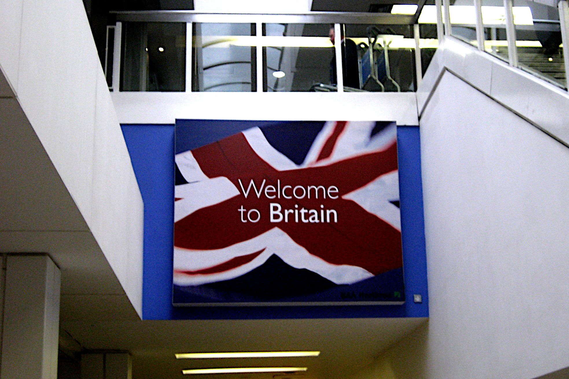 A large sign saying 'Welcome to Britain' against a Union flag