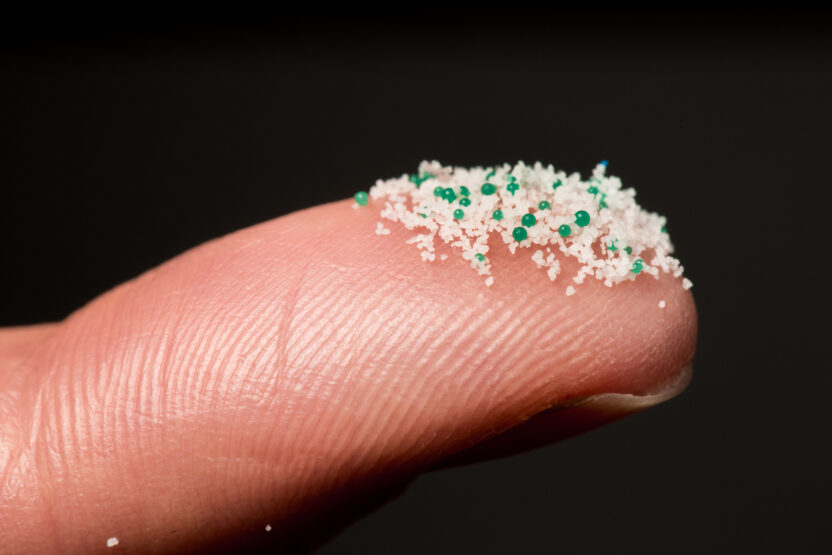 Close up of microbeads on a fingertip