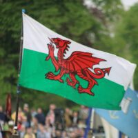 The Welsh flag flying in a parade