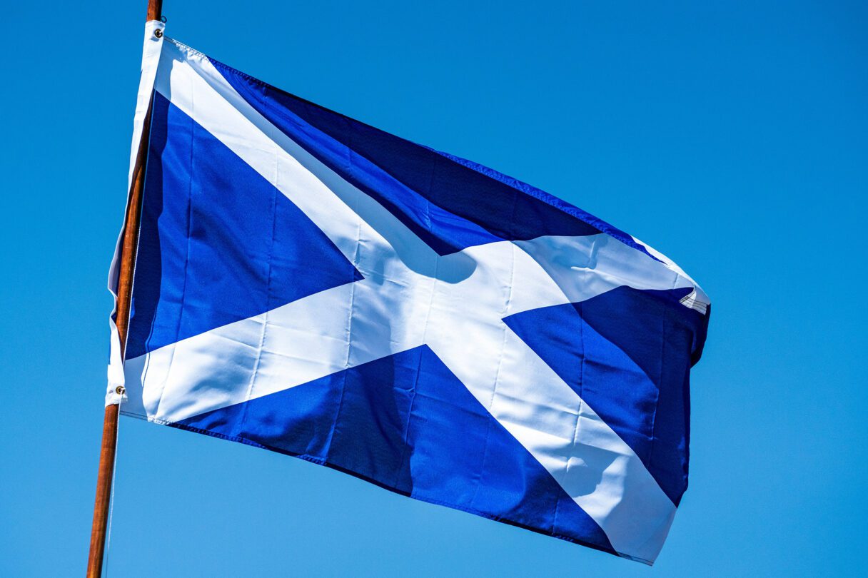 Scottish flag flying against a blue sky
