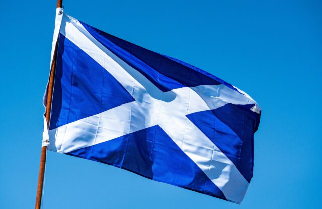 Scottish flag flying against a blue sky