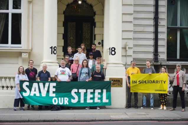 Climate and workers rights groups hold a banner saying save our steel outside Tata Steel HQ