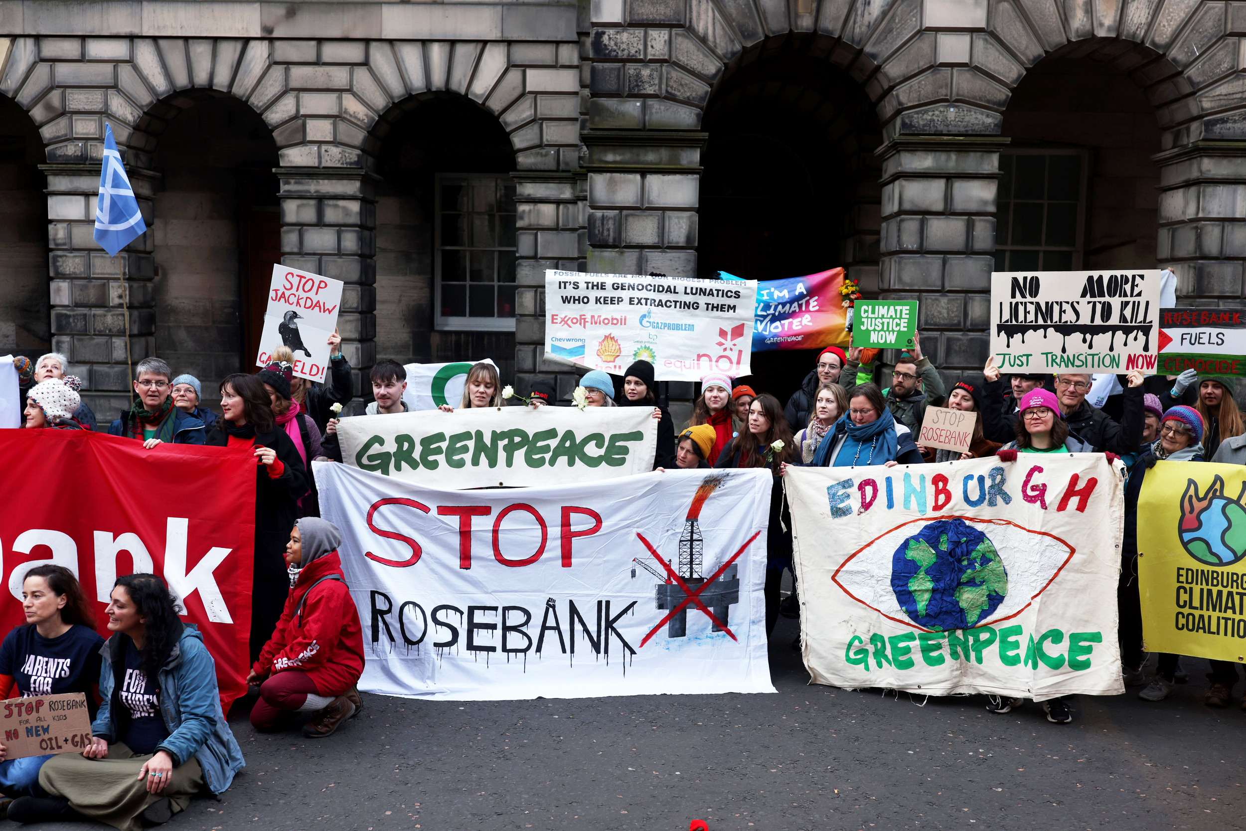 Climate activists hold banners outside Scottish Court of Session before Rosebank and Jackdaw judicial review hearing
